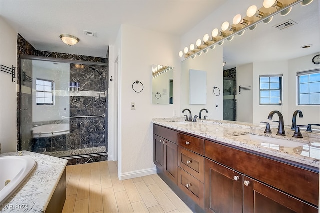 bathroom with vanity, shower with separate bathtub, and hardwood / wood-style flooring