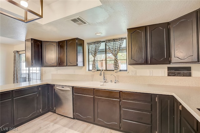 kitchen with sink, plenty of natural light, dark brown cabinets, and light wood-type flooring