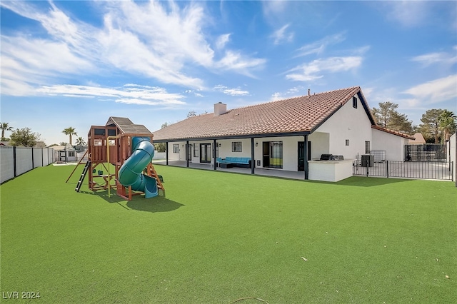 view of play area with a lawn, area for grilling, and central air condition unit