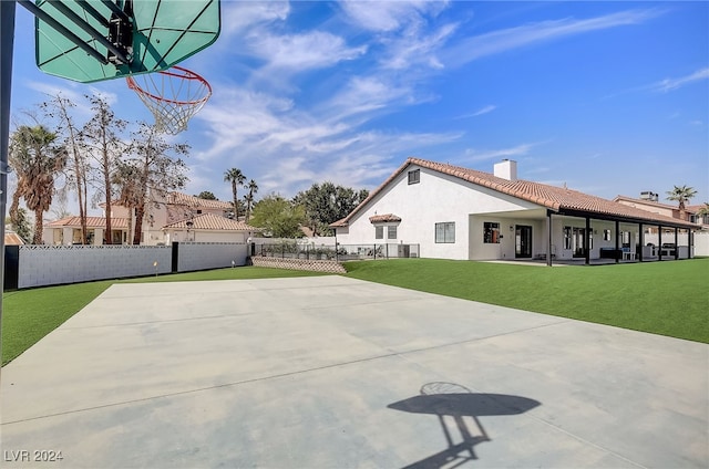 view of basketball court featuring a lawn