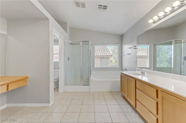 full bathroom with tile patterned floors, vanity, vaulted ceiling, plus walk in shower, and toilet