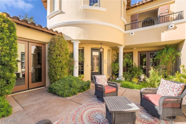 view of patio featuring french doors and a balcony