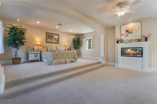 unfurnished bedroom featuring ceiling fan, carpet floors, and decorative columns