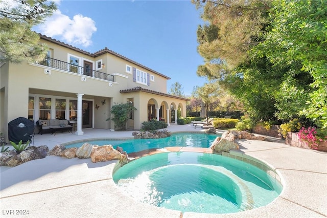 view of swimming pool with an in ground hot tub, outdoor lounge area, grilling area, and a patio area