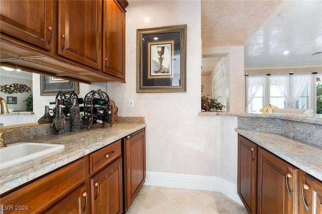 bar with light stone counters, light tile patterned floors, and crown molding