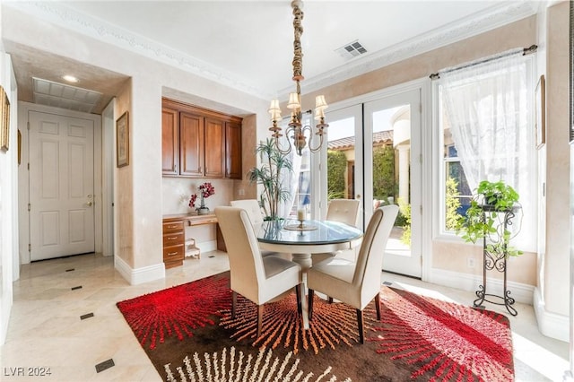 dining space featuring built in desk and ornamental molding