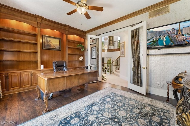 office area featuring built in shelves, dark hardwood / wood-style flooring, ceiling fan, and ornamental molding