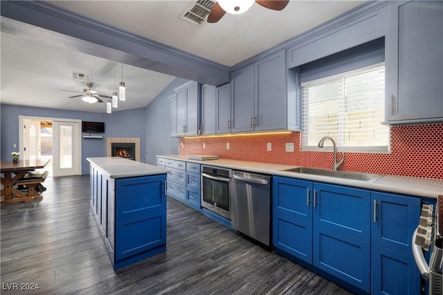 kitchen featuring a wealth of natural light, sink, a center island, and stainless steel appliances