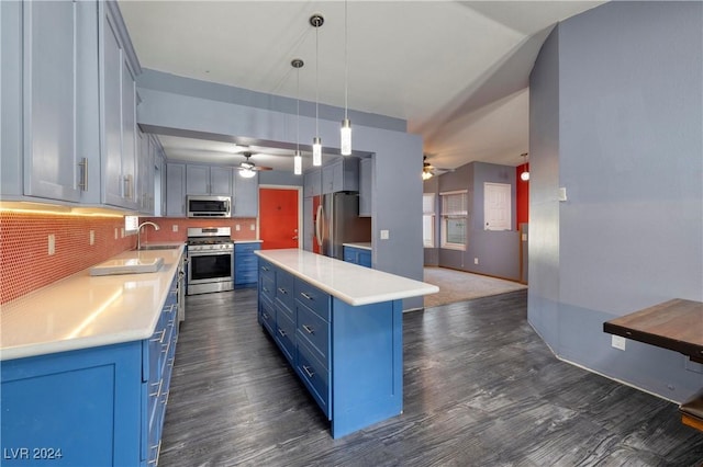 kitchen featuring a center island, dark hardwood / wood-style floors, decorative backsplash, decorative light fixtures, and stainless steel appliances