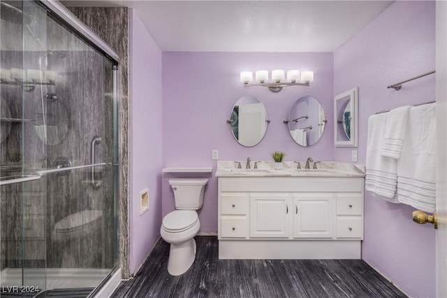 bathroom featuring hardwood / wood-style floors, vanity, toilet, and an enclosed shower