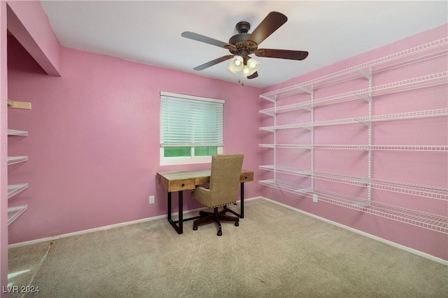 unfurnished office featuring carpet flooring and ceiling fan