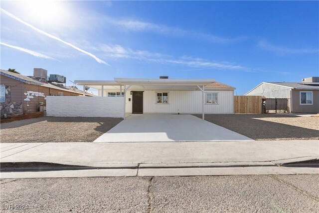 view of front of home featuring a carport and central AC unit