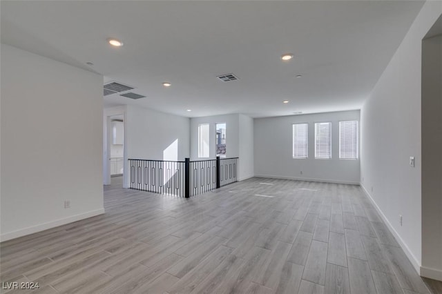 spare room with light hardwood / wood-style flooring