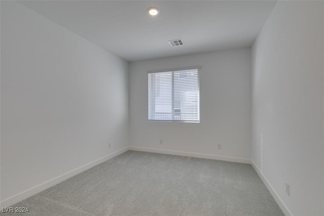 unfurnished room featuring light colored carpet