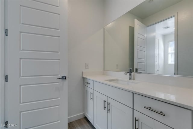 bathroom with hardwood / wood-style floors and vanity