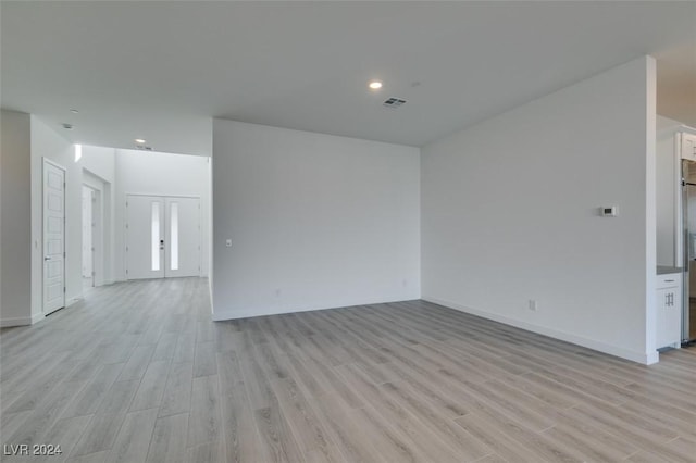 unfurnished room with french doors and light hardwood / wood-style floors