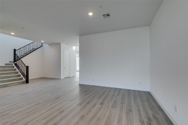 empty room with light hardwood / wood-style flooring