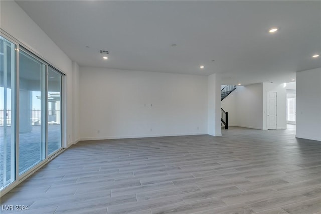 empty room with light hardwood / wood-style floors