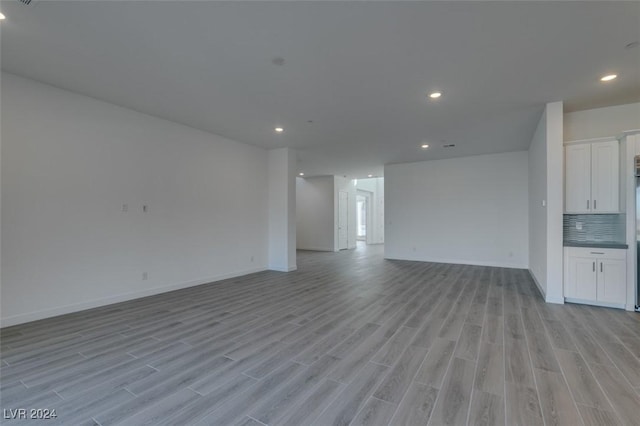 unfurnished living room with light wood-type flooring