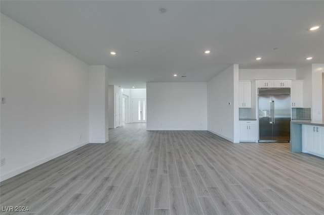 unfurnished living room with light hardwood / wood-style flooring