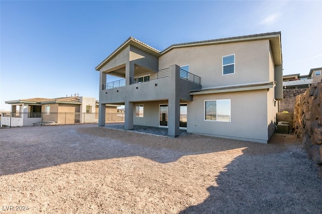 back of property featuring a balcony