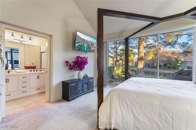 carpeted bedroom featuring connected bathroom, sink, and access to exterior