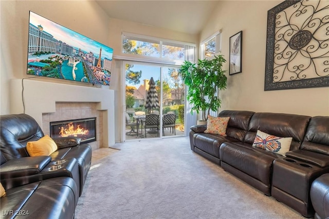 living room featuring a fireplace, light carpet, and vaulted ceiling