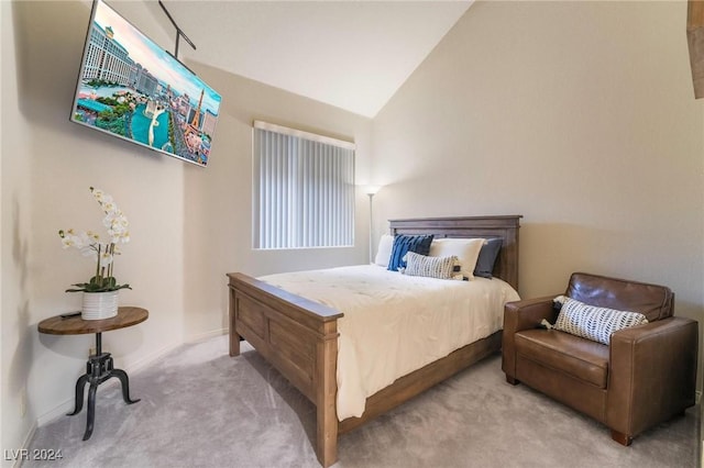 bedroom featuring light colored carpet and vaulted ceiling