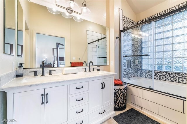 bathroom with vanity, vaulted ceiling, and combined bath / shower with glass door