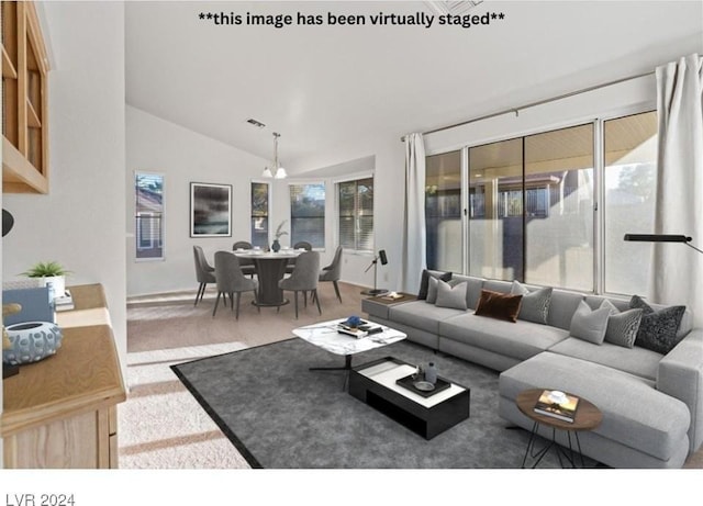 carpeted living room with a chandelier and lofted ceiling