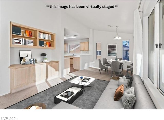 living room featuring a chandelier, light carpet, and vaulted ceiling