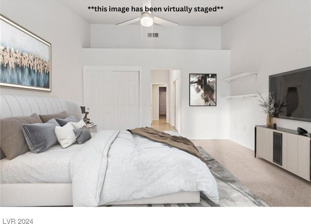 bedroom featuring ceiling fan, light colored carpet, and a closet