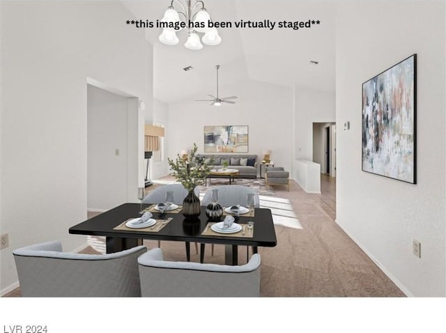 dining area featuring ceiling fan with notable chandelier, light carpet, and high vaulted ceiling