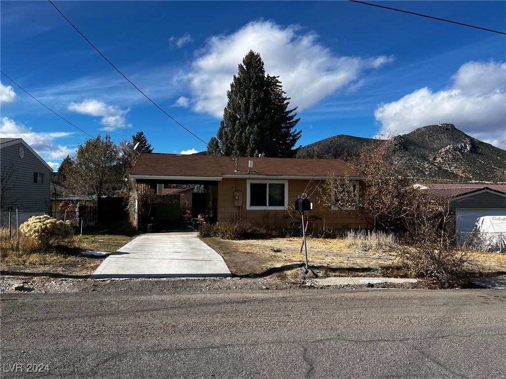 view of front of house featuring a mountain view and a carport