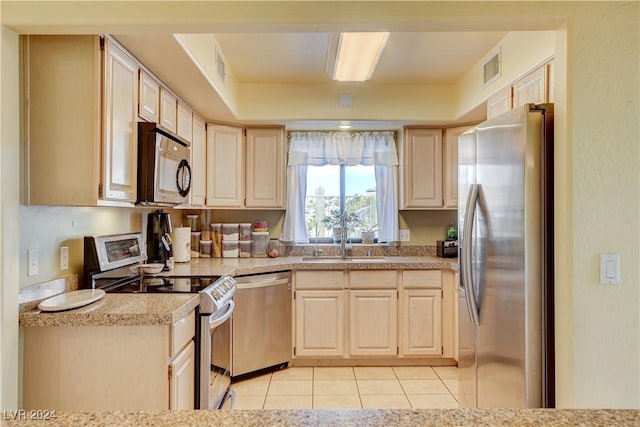 kitchen featuring light tile patterned floors, sink, and appliances with stainless steel finishes