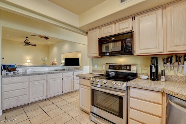 kitchen featuring ceiling fan, light tile patterned floors, and stainless steel appliances