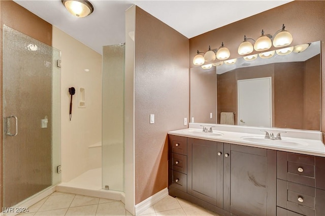 bathroom with tile patterned floors, vanity, and a shower with shower door