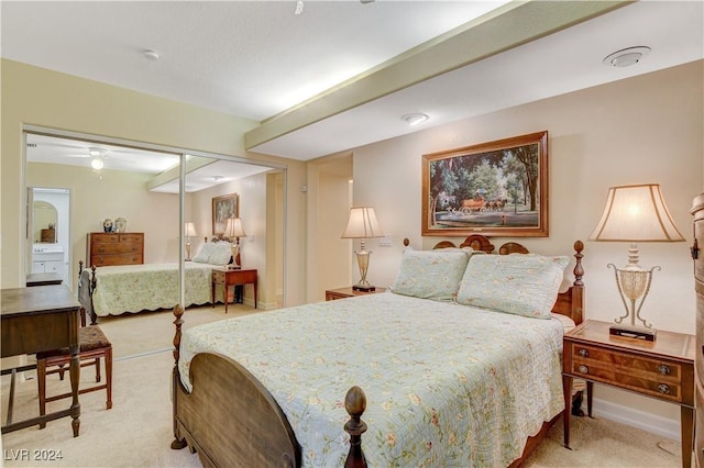 bedroom with a closet and light colored carpet