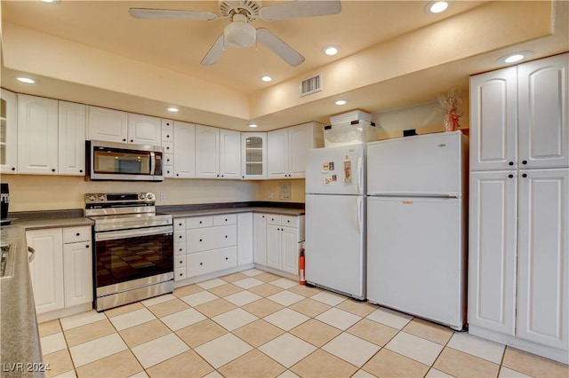 kitchen featuring ceiling fan, light tile patterned floors, white cabinetry, and appliances with stainless steel finishes