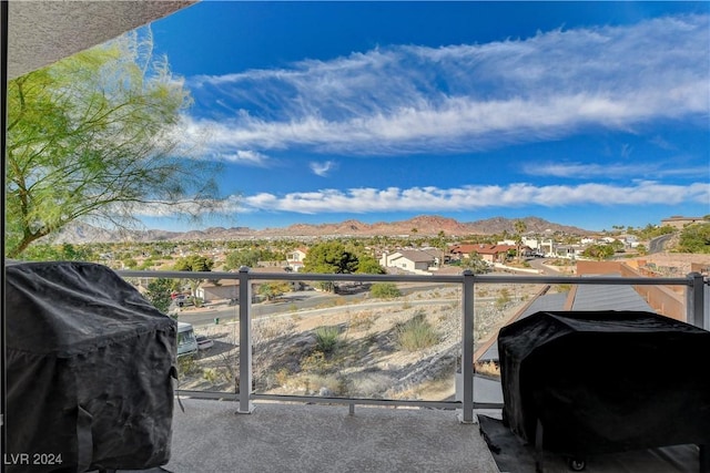 balcony featuring a mountain view and grilling area