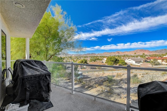 balcony with a mountain view and area for grilling