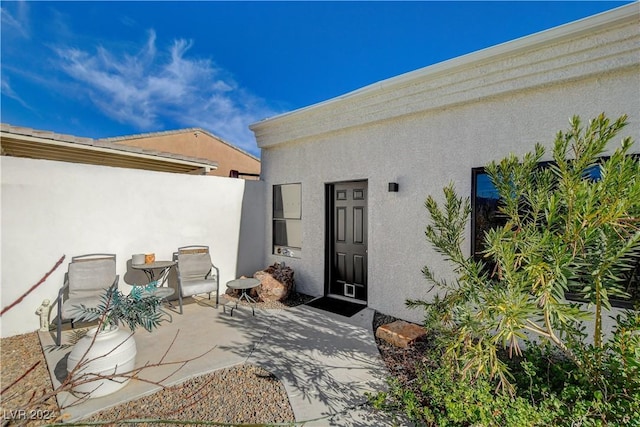 property entrance with a patio