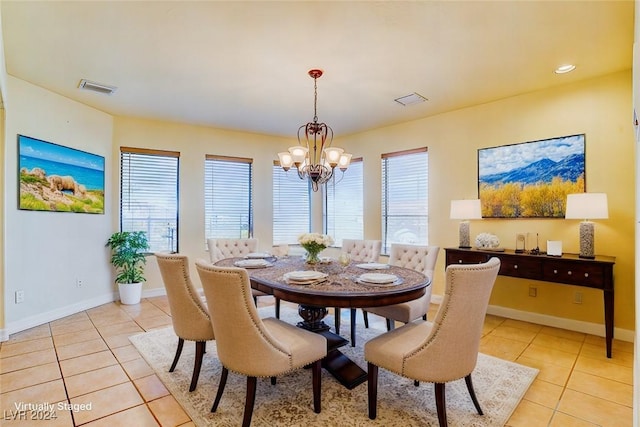 dining area featuring a chandelier, a healthy amount of sunlight, and light tile patterned flooring