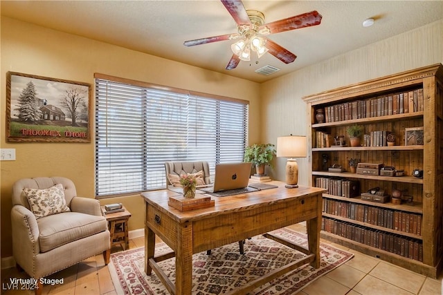 office space with a textured ceiling, ceiling fan, and light tile patterned flooring