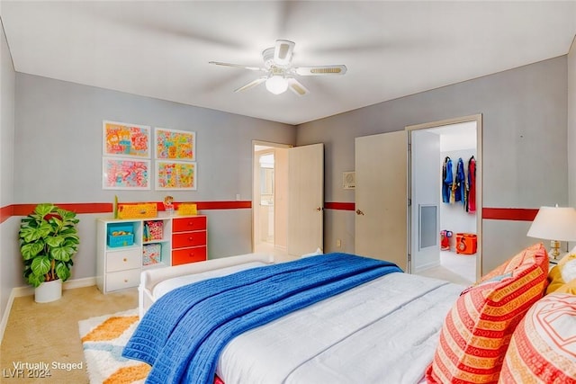 bedroom featuring ceiling fan, light colored carpet, a spacious closet, and a closet