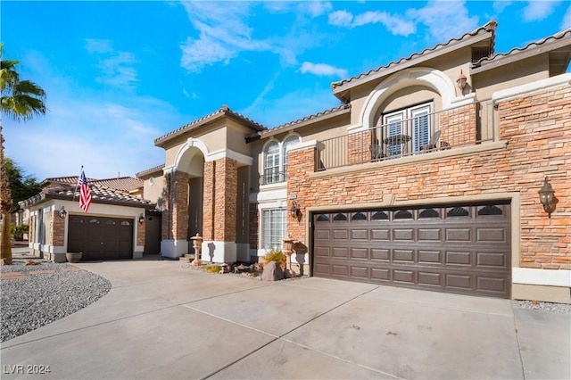 mediterranean / spanish-style home with a balcony and a garage