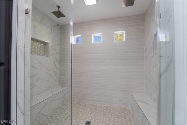 bathroom featuring plenty of natural light and a tile shower