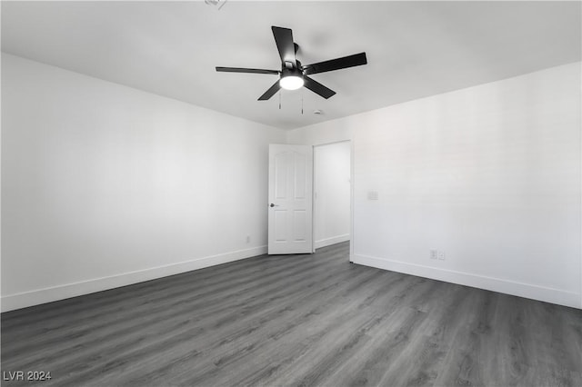 spare room with dark hardwood / wood-style floors and ceiling fan