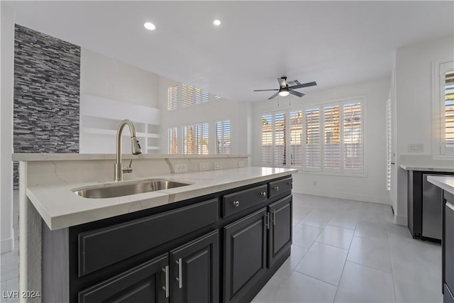 kitchen with a center island, ceiling fan, sink, and light tile patterned floors