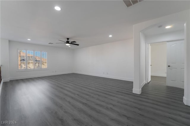 unfurnished room with ceiling fan and dark wood-type flooring